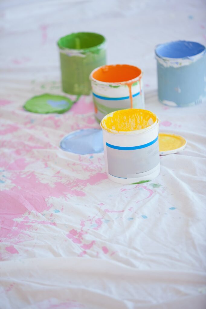 Different paint cans on the floor in the new home
