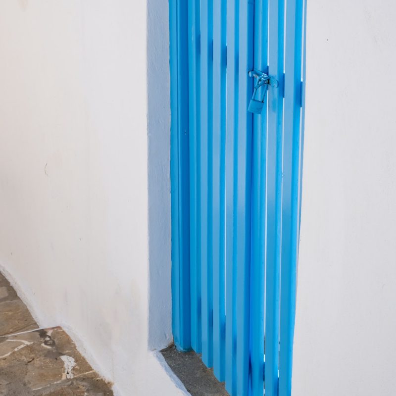 White house blue wood fence gate, Greece. Sifnos island, Cyclades